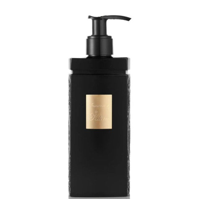 Product image by Kilian featuring a sleek black rectangular pump bottle with a prominent gold label displaying the Kilian logo and "Intoxicated" text on a stark white background