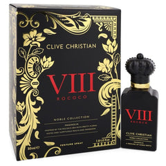 Product photography of Clive Christian VIII Rococo Magnolia perfume spray, showcasing a black box and bottle adorned with intricate gold Rococo floral designs, striking red VIII ROCOCO branding, and the bottle topped with a distinctive black crown stopper