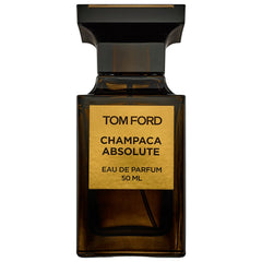 Tom Ford Champaca Absolute Eau de Parfum bottle with a dark amber glass body, a sleek black ribbed cap, and a prominent gold label detailing the fragrance name and 50 ML volume