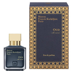 Product photography of Maison Francis Kurkdjian OUD silk mood Eau de parfum from Paris featuring a dark blue square bottle with a gold cap and a matching dark blue box with an ornate gold geometric pattern