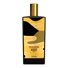 Memo Paris Italian Leather Eau de Parfum perfume bottle, a black rectangular design with a gold cap and a distinctive black and gold label showcasing elegant white wavy lines and an intricate black spiral pattern, bearing the text Italian Leather Eau de Parfum Memo Paris Cuirs Nomades
