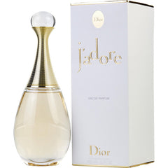 Product photograph of Dior J'adore Eau de Parfum, featuring its iconic hourglass bottle with a gold coiled neck and clear cap, alongside a white box embossed with gold J'adore lettering