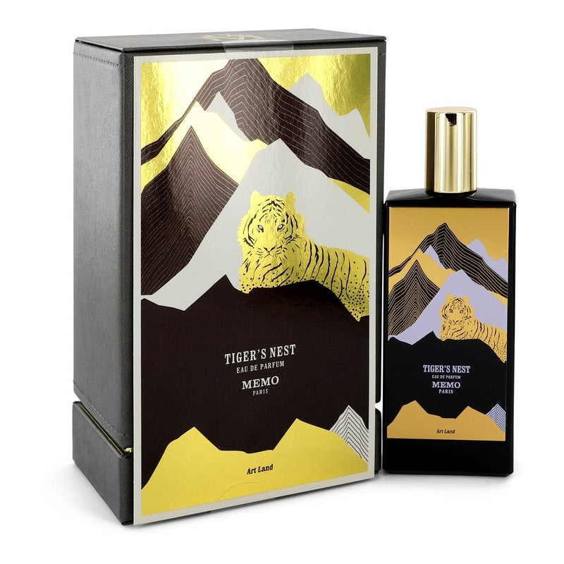 Product photograph of Memo Paris Tiger's Nest Eau de Parfum bottle and box featuring a stylized gold foil tiger in a striking black and white mountain landscape with brown accents and an Art Land inscription