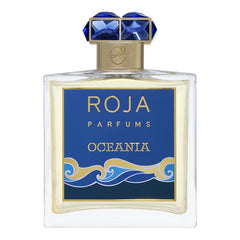 Product image of Roja Parfums Oceania fragrance bottle featuring a clear rectangular design with a deep blue label displaying gold text and an elegant gold and blue wave motif, topped by a gold collar and a distinctive cap set with vibrant blue faceted gemstones