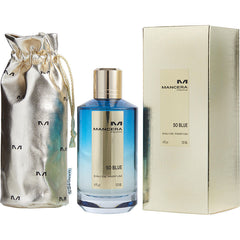 Mancera product photograph featuring a blue gradient So Blue Eau de Parfum bottle with a gold cap and central label, accompanied by a matching textured gold rectangular box and a silver metallic drawstring pouch adorned with repeating M logos