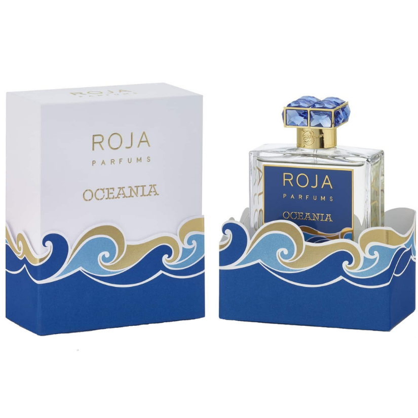 Roja Parfums product photography of the Oceania perfume bottle and its matching box featuring vibrant blue and gold wave patterns a dark blue label and a crystal blue gemstone cap