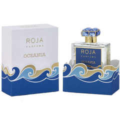 Roja Parfums product photography of the Oceania perfume bottle and its matching box featuring vibrant blue and gold wave patterns a dark blue label and a crystal blue gemstone cap