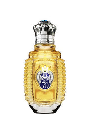Product photo of a Shaik MEN 70 perfume bottle with faceted amber glass, a silver crown cap featuring a blue jewel, and a blue oval label displaying 'MEN 70' and a silver crown emblem