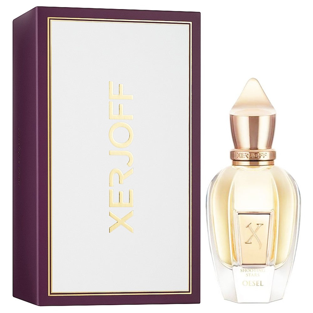 Xerjoff Oesel perfume bottle and its plum purple box with white panel and gold Xerjoff lettering, featuring a clear glass bottle with light golden liquid and a distinctive rose gold pointed cap