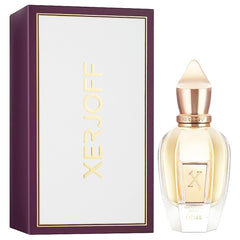 Xerjoff Oesel perfume bottle and its plum purple box with white panel and gold Xerjoff lettering, featuring a clear glass bottle with light golden liquid and a distinctive rose gold pointed cap