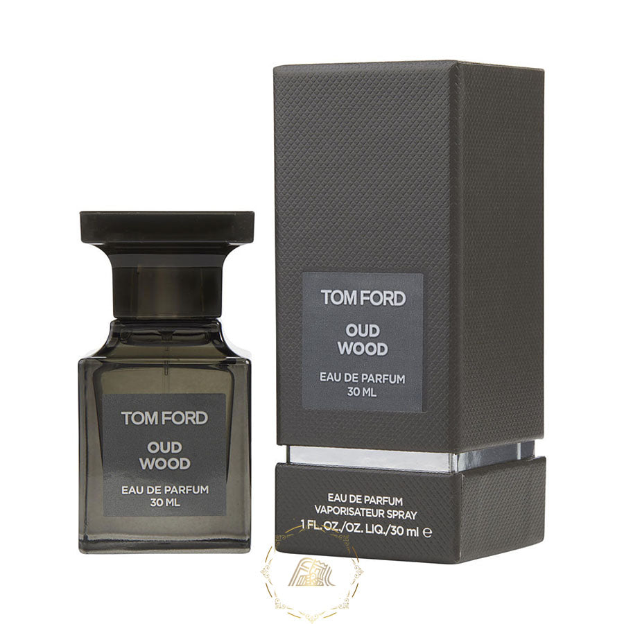 Product photography of Tom Ford Oud Wood Eau de Parfum 30 ML, a distinctive dark charcoal grey rectangular bottle with a bold black cap positioned next to its matching textured grey box, both displaying the fragrance details