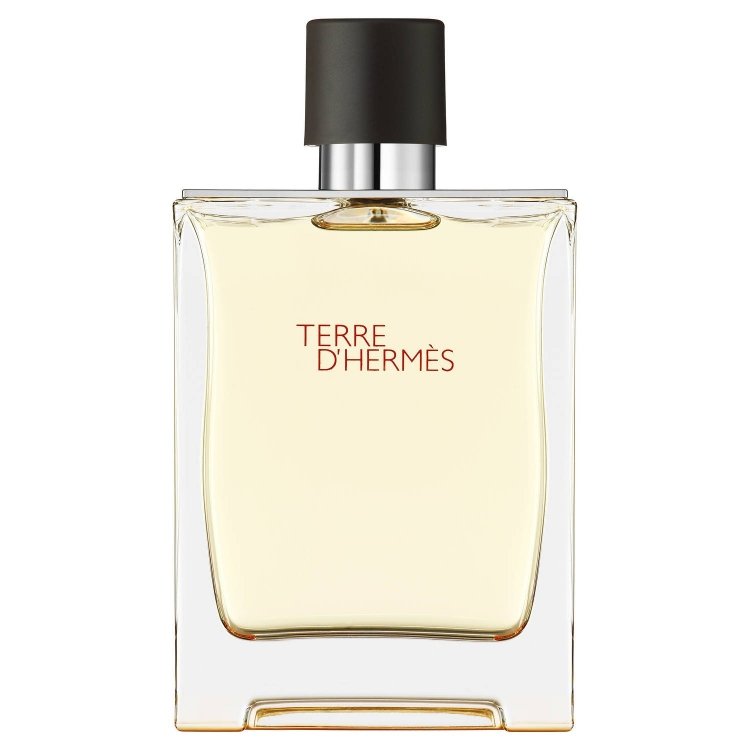 Still life product photograph of the Hermès Terre d'Hermès fragrance bottle featuring a clear rectangular glass design, amber-toned liquid, a dark brown cap, and prominent red text on a pristine white background